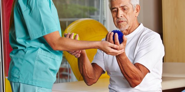 Senior,Man,With,Spikey,Balls,In,Gym,With,Physiotherapist